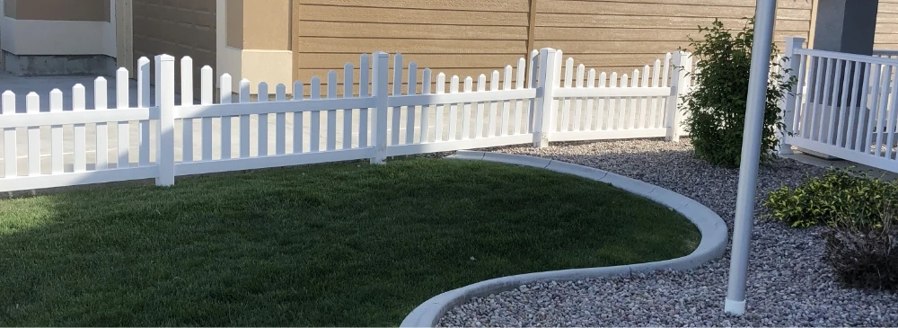 white picket fence installation along a house